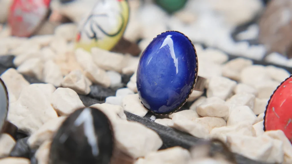 blue gemstone ring displayed on a table